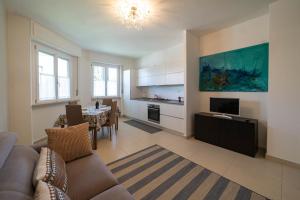 a living room with a couch and a dining room at DINO'S HOME in Iseo
