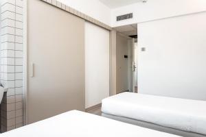 Postel nebo postele na pokoji v ubytování Hotel Carlo Felice Sassari
