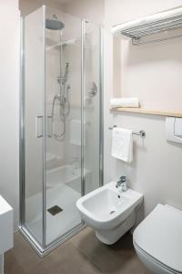 a bathroom with a shower and a toilet and a sink at Hotel Carlo Felice in Sassari