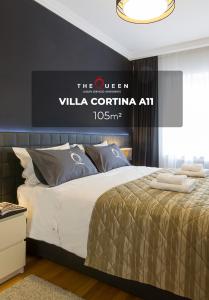a bedroom with a bed and a sign that reads the queen villa cortina at The Queen Luxury Apartments - Villa Cortina in Luxembourg