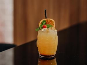 a drink sitting on a table with an orange slice at Novotel Paris Centre Tour Eiffel in Paris