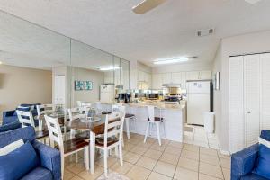 a kitchen and dining room with a table and chairs at Southwind C-2 in Panama City Beach