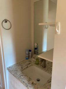 a bathroom with a sink and a mirror at Private Single Room with Shared Bathroom 536C in Toronto