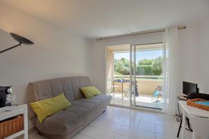 un soggiorno con divano e balcone di Casa Maria Beach a Santa-Lucia-di-Moriani