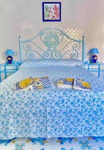 a bedroom with a blue bed with pillows on it at AMALFI ROOM ~ Camera indipendente con Bagno interno per Max 3/4 Persone in Palinuro