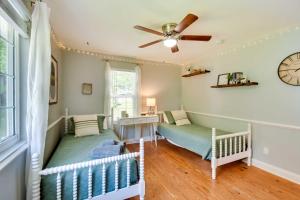 a room with a crib and a ceiling fan at Georgia Vacation Rental with Covered Deck and Patio in Dahlonega