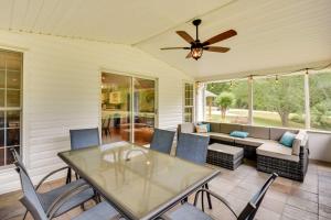 a screened in porch with a glass table and chairs at Georgia Vacation Rental with Covered Deck and Patio in Dahlonega