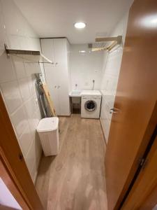 a small bathroom with a washing machine and a washer at Piso céntrico recién reformado in Torredembarra