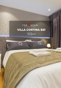a bedroom with a bed with a sign on the wall at The Queen Luxury Apartments - Villa Cortina in Luxembourg