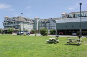two picnic tables in a field in front of a building at FFR202 - Atlantic Splash in Kill Devil Hills