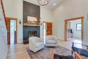 a living room with two chairs and a fireplace at Bright Bluemont Home with On-Site Pond and Mtn Views! in Paris