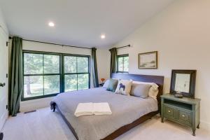 a bedroom with a large bed with a large window at Bright Bluemont Home with On-Site Pond and Mtn Views! in Paris