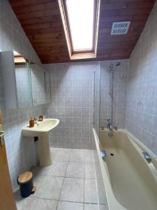 bagno con lavandino, vasca e lavandino di Gîte de la Borderie a Saint-Silvain-sous-Toulx