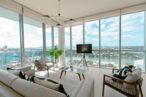 salon z białymi meblami i dużymi oknami w obiekcie Monte Carlo Miami Beach w Miami Beach