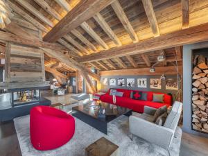 a living room with red furniture and a fireplace at Chalet de prestige au cœur de Saint Martin de Belleville, à quelques pas des pistes - FR-1-570-38 in Saint-Martin-de-Belleville