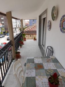 a balcony with a table and chairs on a balcony at Atico augaboa in Cangas de Morrazo