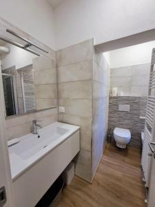 a bathroom with a white sink and a toilet at Nido d'amore a Ventimiglia in Ventimiglia