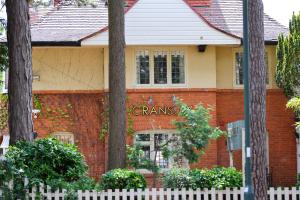 a brick house with a white fence in front of it at Cransley Apart Hotel in Bournemouth