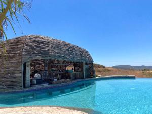 uma pequena cabana ao lado de uma piscina em Maple Resort 