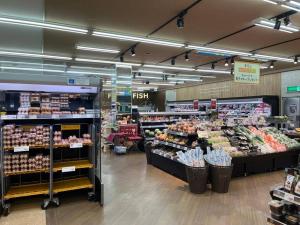 a grocery store aisle with a lot of produce at Inari-Home in Kyoto