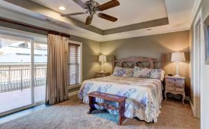 a bedroom with a bed and a large window at CSC3H Rum Runner in Kill Devil Hills +47 photos