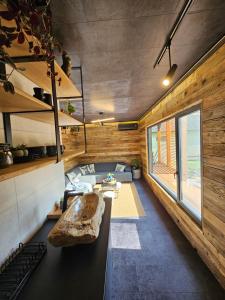 a living room of a tiny house with a couch at Meszes Apartman in Kalocsa