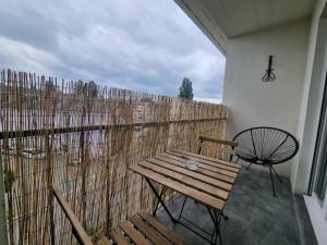 a balcony with a wooden bench and a fence at Les Alliés in Mulhouse
