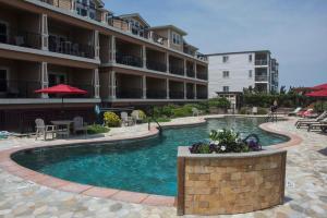 a swimming pool in front of a building at CSC3O - Lands End in Kill Devil Hills