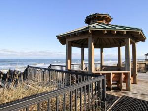 a wooden gazebo on a boardwalk next to the beach at CSC3S - Drive In in Kill Devil Hills
