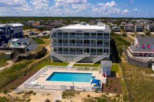 an aerial view of a large building with a swimming pool at SC202 Coastal LegaSea in Kill Devil Hills