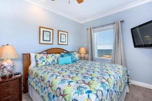 a bedroom with a bed and a flat screen tv at RSR3C - Sunsets Galore in Rodanthe +46 photos