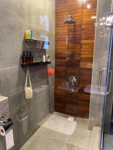 a shower with a glass door in a bathroom at luxurious 2bed's duplex sheikh zayed beverly hills in Sheikh Zayed