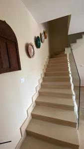 a staircase in a house with a stair case at luxurious 2bed's duplex sheikh zayed beverly hills in Sheikh Zayed