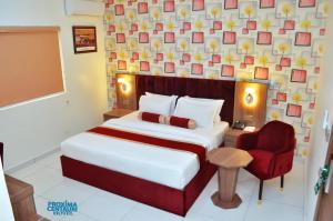 A bed or beds in a room at Proxima Centauri Hotel