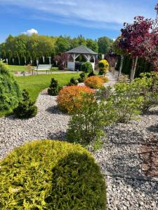 a garden with colorful bushes and a gazebo at Malibu in Brzeźnica