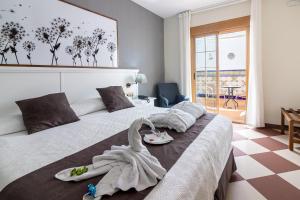 Postel nebo postele na pokoji v ubytování Hotel Avenida Tropical by Bossh! Hotels