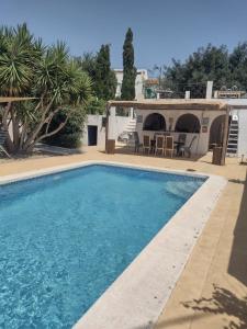 a swimming pool in front of a house at Lavender Lodge Almeria in Arboleas