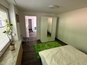 a white room with a bed and a mirror at Nordsee Wohlfühloase in Norden
