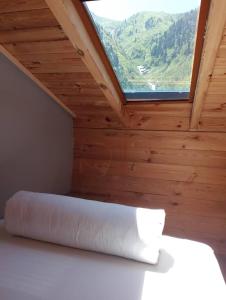 a bed in a wooden room with a window at Ayder Rainbow Gokkusagi in Ayder Yaylasi