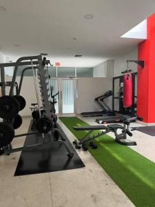 a gym with two tread machines and a punching bag at Coffee Suite, wifi, Parqueo, gym & piscina! in Guayaquil