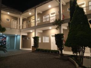 a apartment building with a balcony at night at Smart Hotel in Registro
