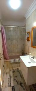 a bathroom with a sink and a bath tub at Buenavista in Acantilado de los Gigantes