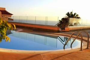 a swimming pool with a view of the ocean at Buenavista in Acantilado de los Gigantes +16 photos