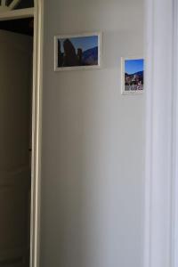 two pictures on a wall next to a door at Buenavista in Acantilado de los Gigantes