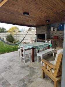 a patio with a table and chairs and a hammock at CASA YOSELI in General Juan Madariaga
