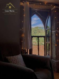a room with a couch and a window with a view at Casa Maria in Terras de Bouro +11 photos