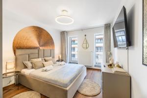 a bedroom with a large bed and a flat screen tv at Balance Apartments Complex Qualis Brasov in Braşov