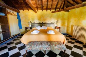 a bedroom with a bed and a checkered floor at Casa Rural Álamo Grande in Layos