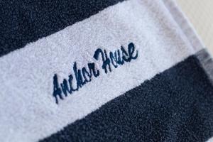 a white and black blanket with the word antiline on it at The Anchor House in Symi