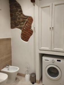 a bathroom with a sink and a washing machine at Casa Erica in Cortona +2 photos